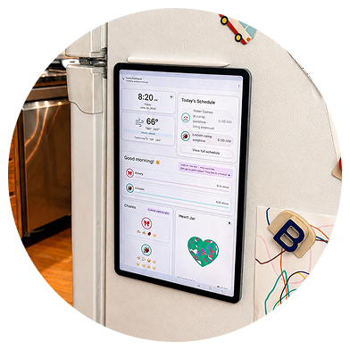 The family dashboard running on a tablet stuck to the fridge